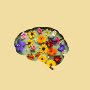 Paper cut brain symbol and flowers on yellow background