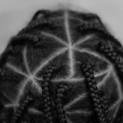 https://unsplash.com/photos/ptyj_QoPRsQ [ID: A close-up photograph of the back of a persons head, gives us a look into the triangular box braids that cover their scalp. The picture is in black and white.]